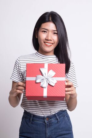 Young Asian woman with a gift box on white backgroundの写真素材