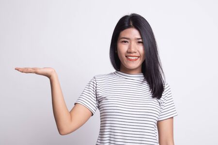 Beautiful young Asian woman show palm hand on white backgroundの写真素材