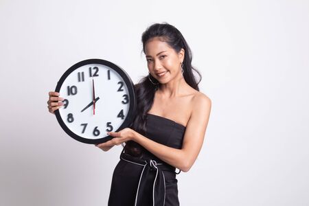 Young Asian woman with a clock on white backgroundの写真素材