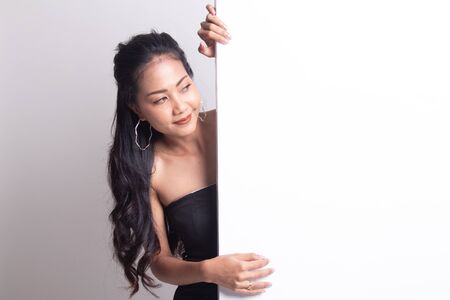 Young Asian woman with blank sign on white backgroundの写真素材