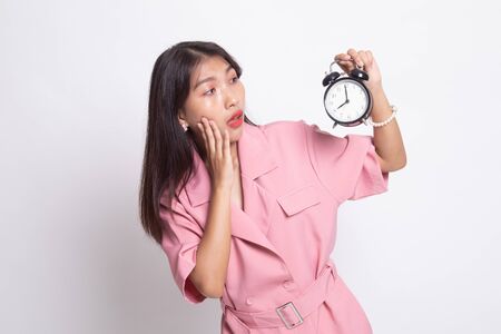 Young Asian woman is stressed with a clock on white background.の写真素材
