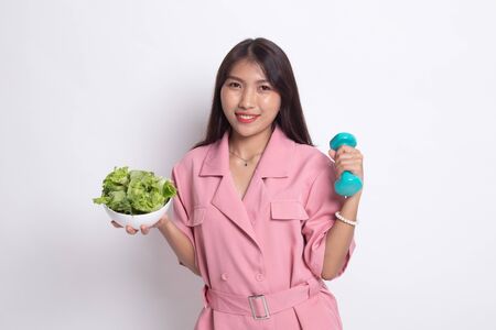 Healthy Asian woman with dumbbells and salad on white background.の写真素材