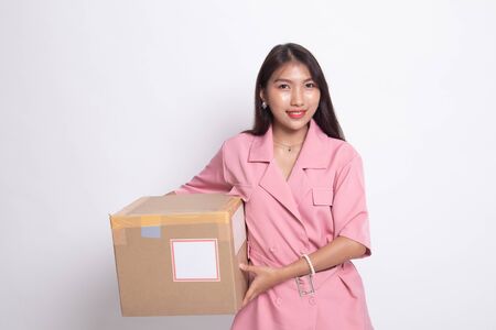 Delivery, relocation and unpacking.  young asian woman holding cardboard box on white background.の写真素材