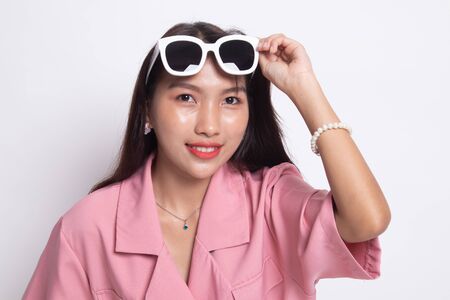 Portrait of a beautiful young asian girl in sunglasses on white background.の写真素材