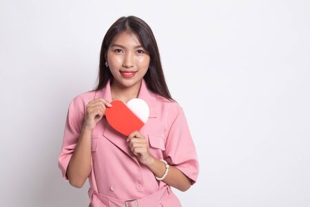 Asian woman with red heart on white background.の写真素材