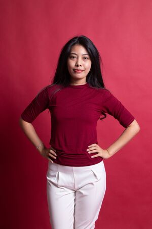 Portrait of beautiful young Asian woman on red background.の写真素材