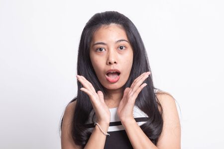 Shocked young Asian woman on white backgroundの写真素材