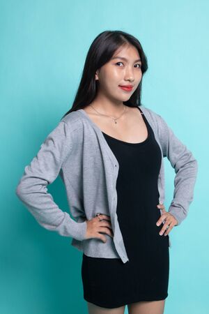 Portrait of beautiful young Asian woman on cyan background.の写真素材
