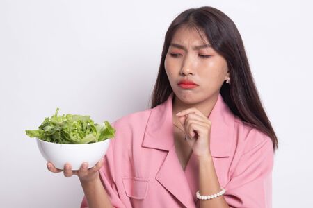 Asian woman hate salad on white background.の写真素材