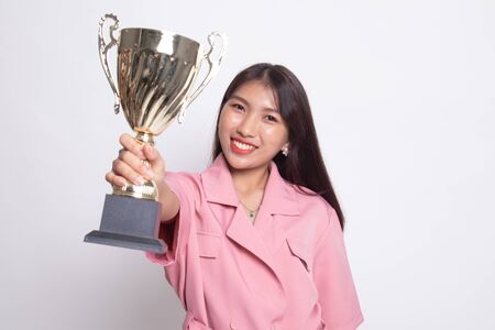 Successful young asian woman holding a trophy on white background.の写真素材