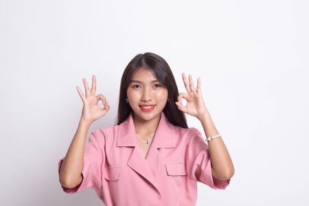 Asian woman show double OK hand sign  and smile on white background.の写真素材