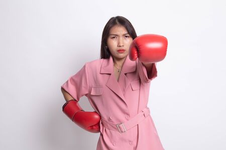 Young Asian woman with red boxing gloves on white background.の写真素材