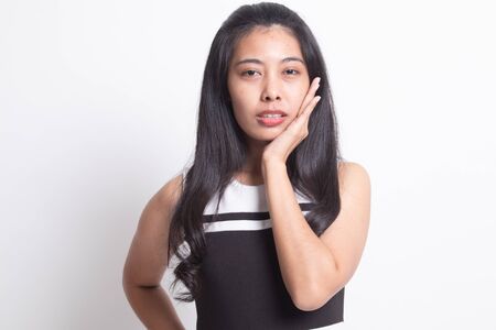 Young Asian woman got toothache on white backgroundの写真素材