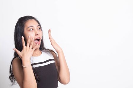 Beautiful young Asian woman shocked  and look up on white backgroundの写真素材