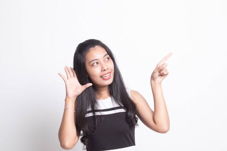 Excited Asian woman point to blank space on white backgroundの写真素材