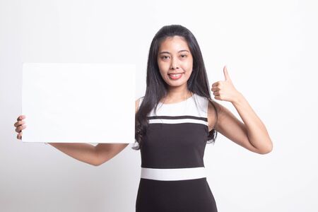Young Asian woman show thumbs up with  white blank sign on white backgroundの写真素材