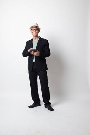 an adult asian man with a computer tablet on white backgroundの写真素材