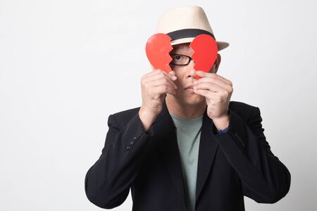 adult asian man with broken heart on white backgroundの写真素材