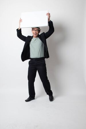 an adult asian man  with white blank sign on white backgroundの写真素材