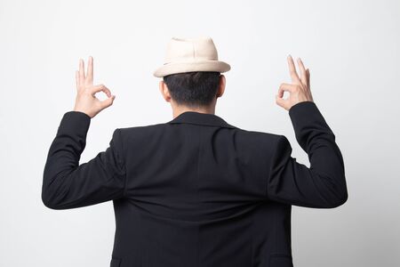 Back view of adult asian man  show double OK hand sign on white backgroundの写真素材