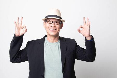 adult asian man show double OK hand sign  and smile on white backgroundの写真素材