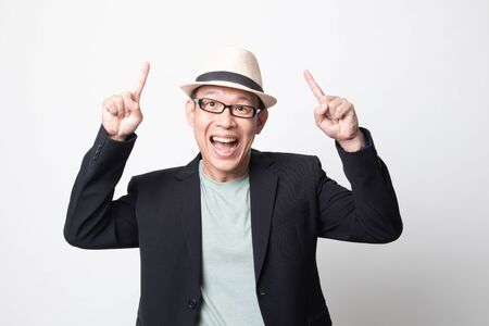 an adult asian man  point to blank space on white backgroundの写真素材