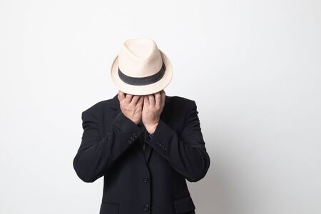 Sad adult asian man cry with palm to face on white backgroundの写真素材