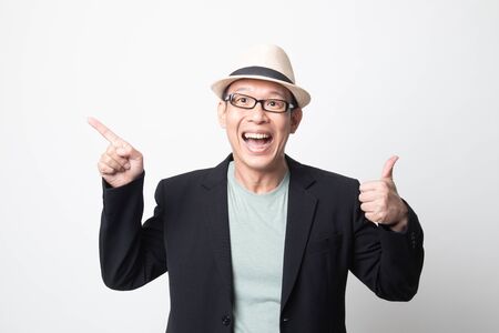 an adult asian man  point and thumbs up on white backgroundの写真素材