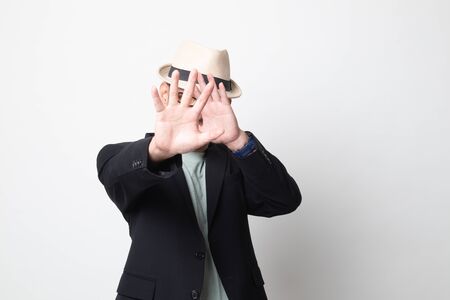 adult asian man  hide his face on white backgroundの写真素材