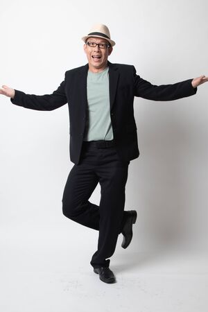 Full body of happy adult asian man on white backgroundの写真素材