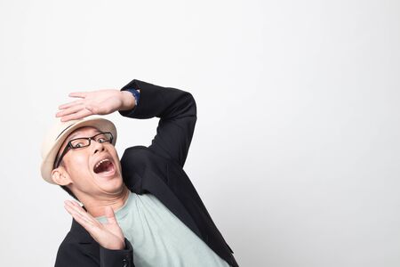 Excited adult asian man   look up on white backgroundの写真素材