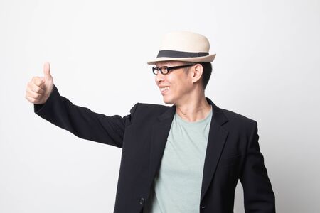 adult asian man  thumbs up  and smile on white backgroundの写真素材