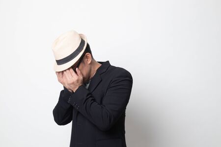 Sad  adult asian man cry with palm to face on white backgroundの写真素材