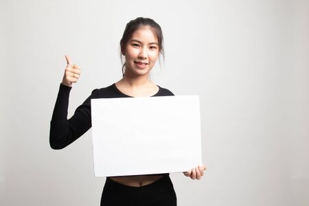 Young Asian woman show thumbs up with  white blank sign on white backgroundの写真素材