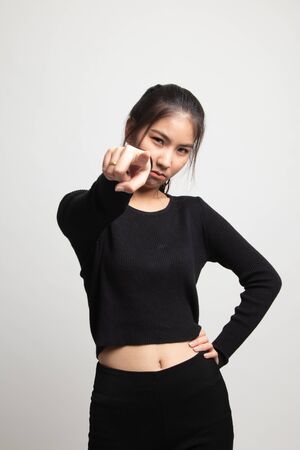 Young Asian woman angry and point to camera on white backgroundの写真素材