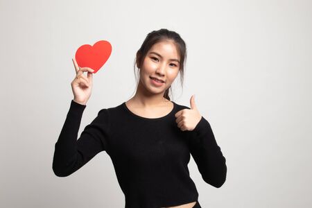 Asian woman thumbs up with red heart on white backgroundの写真素材