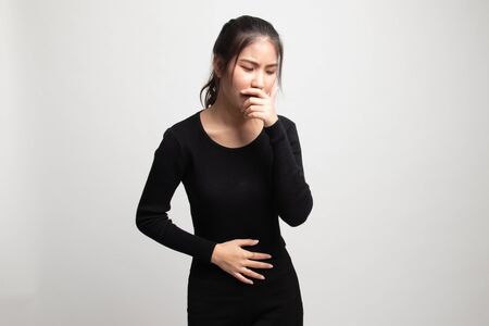 Young Asian woman got stomachache about to vomit on white backgroundの写真素材