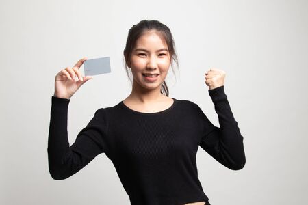 Young Asian woman fist pump with blank card on white backgroundの写真素材