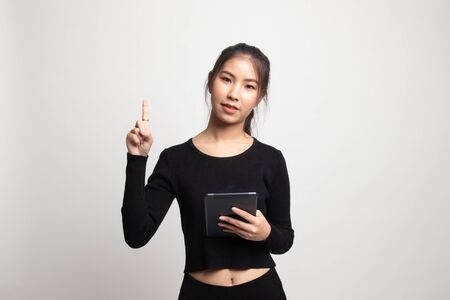 Young Asian woman with a computer tablet on white backgroundの写真素材