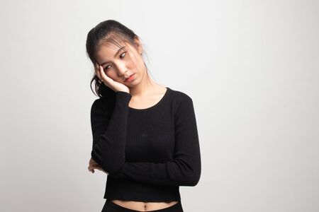 Beautiful young Asian woman get bored on white backgroundの写真素材