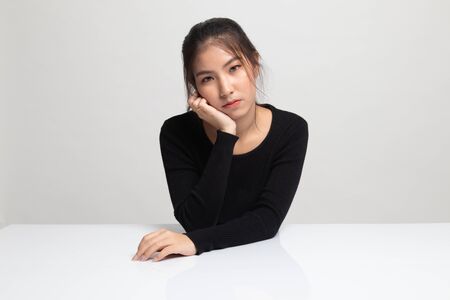 Asian girl is getting bore on white backgroundの写真素材