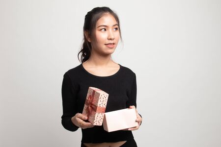 Young Asian woman open a gift box on white backgroundの写真素材