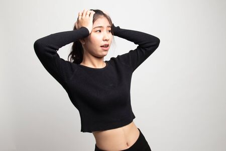 Stressed young Asian businesswoman scream out on white backgroundの写真素材