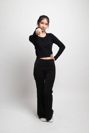 Full body of beautiful young asian woman pointing on white backgroundの写真素材