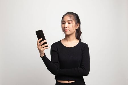 Young Asian woman with mobile phone on white backgroundの写真素材