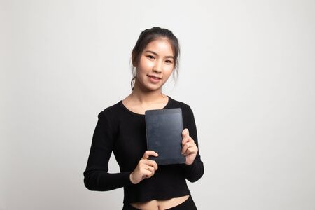 Young Asian woman with a computer tablet on white backgroundの写真素材