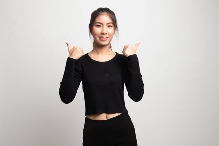 Young Asian woman show two thumbs up on white backgroundの写真素材