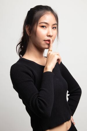 Asian girl show quite hand sign on white backgroundの写真素材