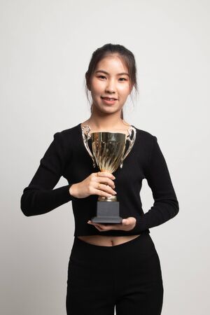 Successful young asian woman holding a trophy on white backgroundの写真素材