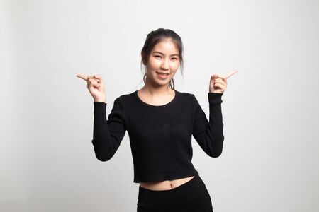 Young Asian woman point to left and right on white backgroundの写真素材